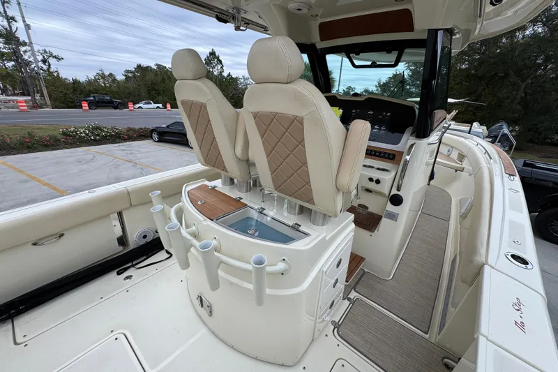 Slide: The Image of 2020 Chris-Craft Catalina 30 interior with helm seats and fishing rod holders. - 40