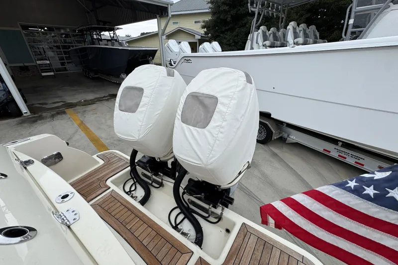 Slide: The Image of 2020 Chris-Craft Catalina 30 with covered outboard motors and American flag. - 43