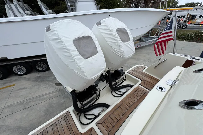 Slide: The Image of 2020 Chris-Craft Catalina 30 with covered outboard motors and American flag on deck. - 44