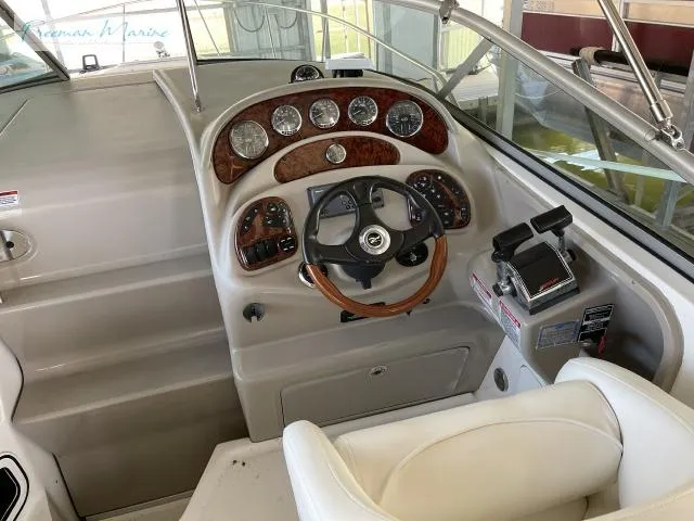 Slide: The Image of 2007 Sea Ray 280 Sundancer helm with wood-accented dashboard and steering wheel. - 11