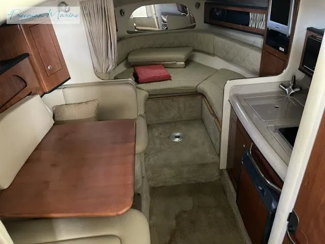 Slide: The Image of 2007 Sea Ray 280 Sundancer cabin interior with seating, table, and kitchenette. - 13