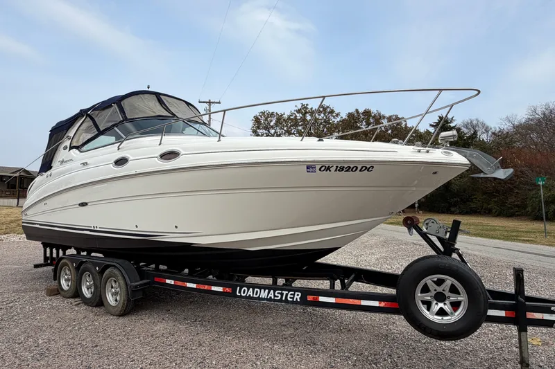 Slide: The Image of 2007 Sea Ray 280 Sundancer boat on a Loadmaster trailer, parked outdoors. - 21