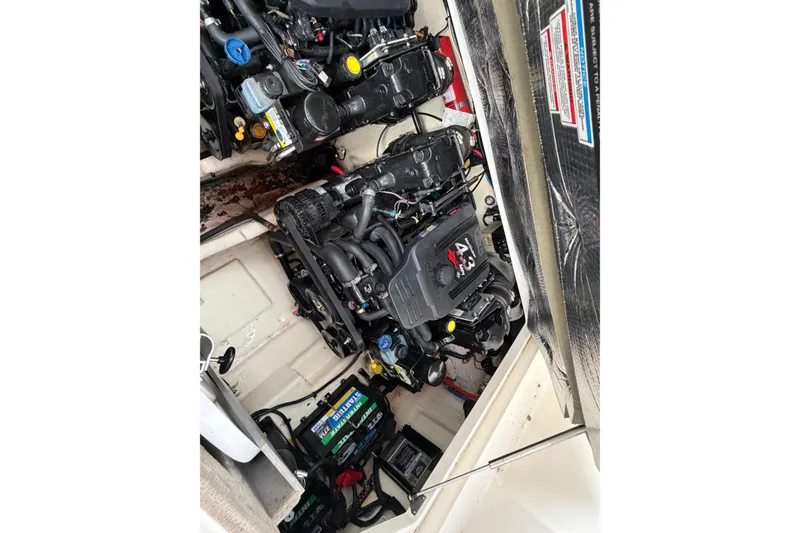 Slide: The Image of Engine compartment of a 2007 Sea Ray 280 Sundancer boat, showing dual engines and battery. - 27