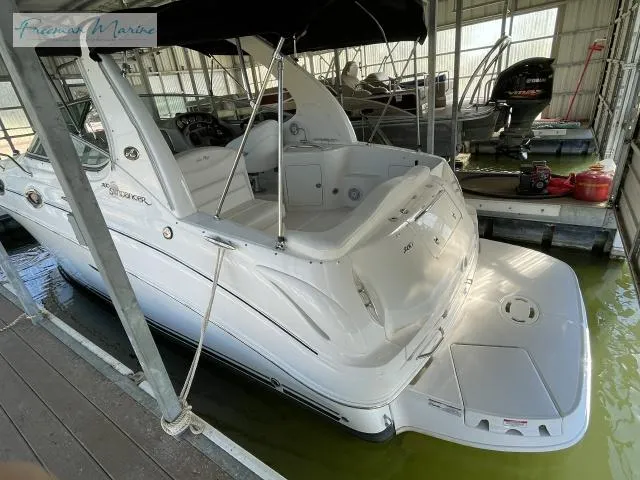 Slide: The Image of 2007 Sea Ray 280 Sundancer boat docked in a marina, featuring sleek white design. - 7