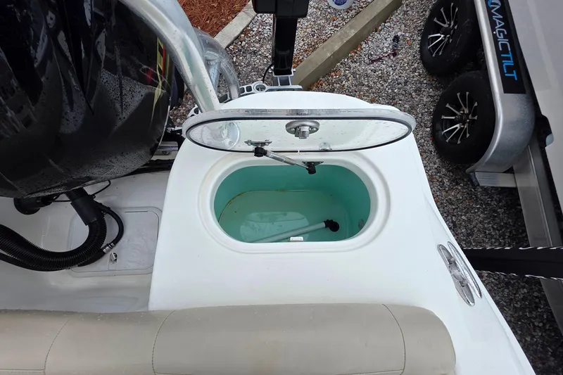Slide: The Image of 2018 NauticStar 2302 Legacy boat livewell with open lid, showcasing interior. - 11
