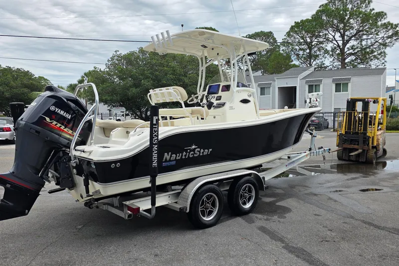 Slide: The Image of 2018 NauticStar 2302 Legacy boat on trailer with Yamaha outboard motor. - 3