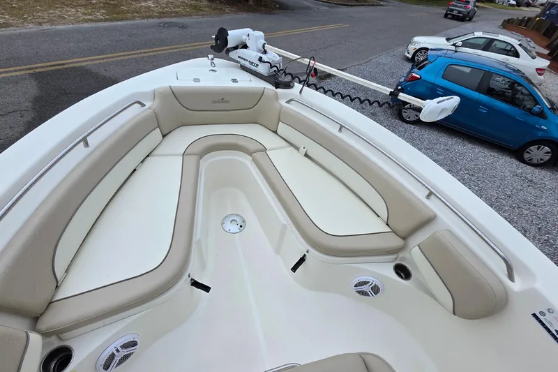 Slide: The Image of 2018 NauticStar 2302 Legacy boat with beige seating and trolling motor. - 6