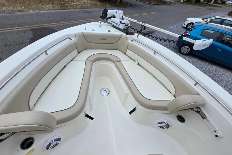 Slide: The Image of 2018 NauticStar 2302 Legacy boat interior with beige seating and modern design. - 8