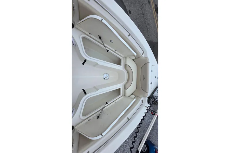 Slide: The Image of 2018 NauticStar 2302 Legacy boat interior with storage compartments and seating. - 9