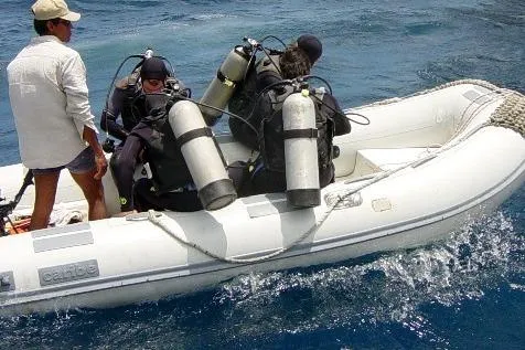 Slide: The Image of 2024 Caribe C-12 inflatable boat, white with gray accents, side view. - 7