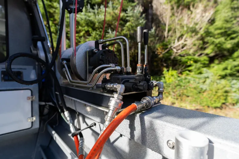 Slide: The Image of Hydraulic system on 2021 KingFisher 2825 Coastal Express boat, surrounded by forest. - 14