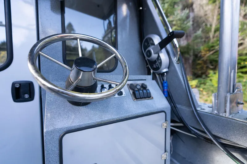 Slide: The Image of Steering wheel and controls of 2021 KingFisher 2825 Coastal Express boat. - 15