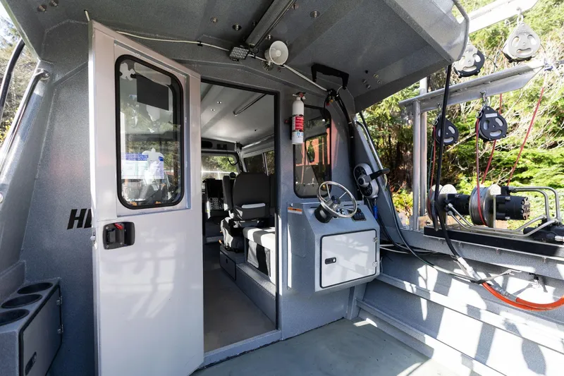 Slide: The Image of Interior of 2021 KingFisher 2825 Coastal Express boat, featuring helm and seating area. - 18