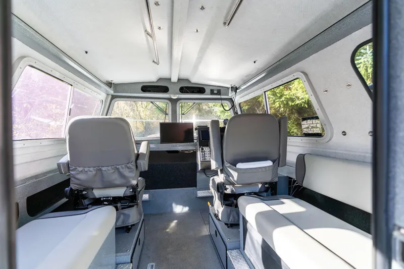 Slide: The Image of Interior of 2021 KingFisher 2825 Coastal Express boat with seating and control panel. - 19