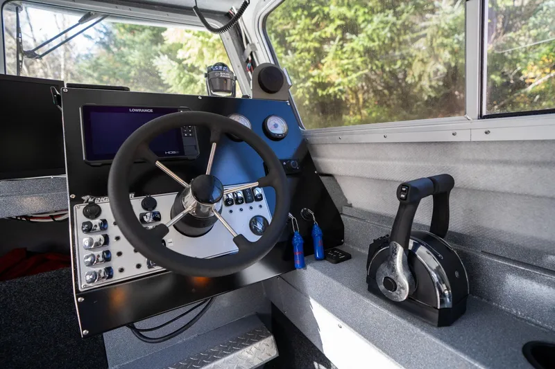 Slide: The Image of 2021 KingFisher 2825 Coastal Express boat cockpit with steering wheel and control panel. - 22