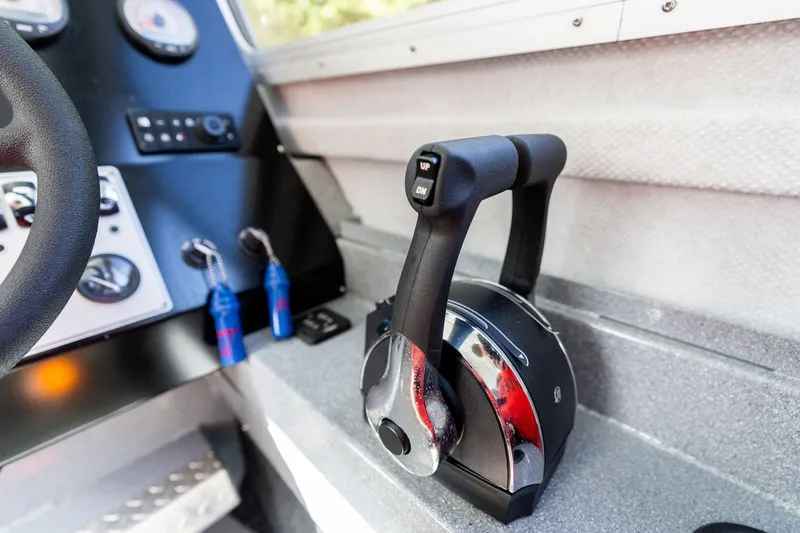 Slide: The Image of Control panel of 2021 KingFisher 2825 Coastal Express boat, featuring throttle and gauges. - 26