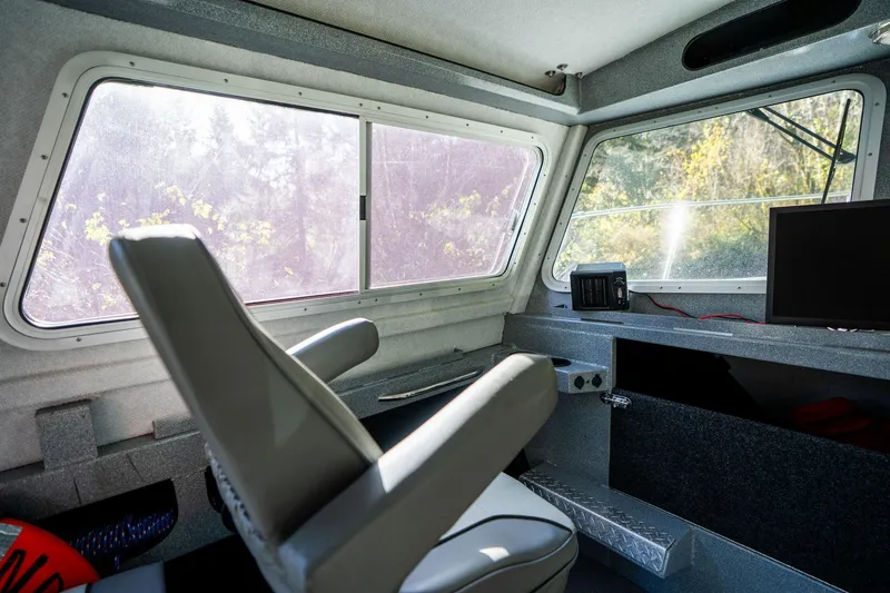 Slide: The Image of Interior of 2021 KingFisher 2825 Coastal Express boat, featuring helm and seating. - 30