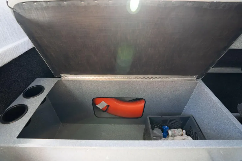 Slide: The Image of Open storage compartment in 2021 KingFisher 2825 Coastal Express boat, featuring safety equipment. - 38