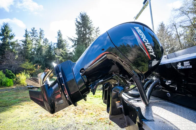 Slide: The Image of Mercury outboard motor on 2021 KingFisher 2825 Coastal Express, surrounded by lush greenery. - 4