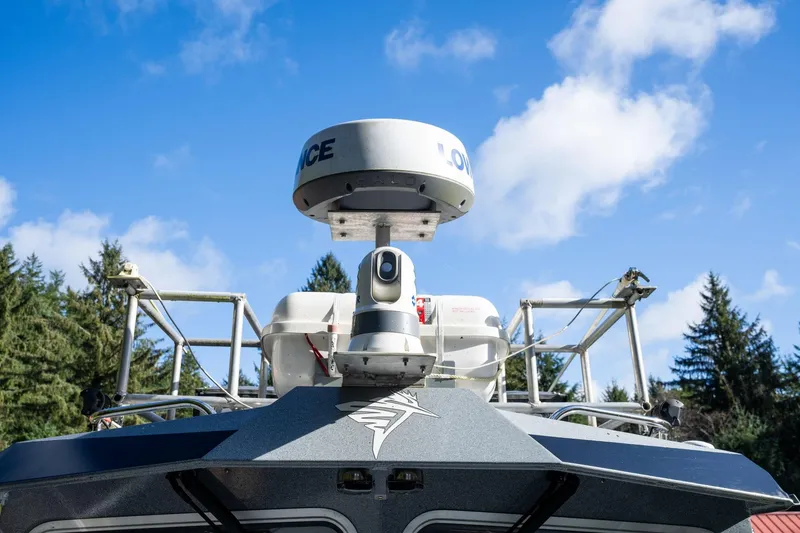 Slide: The Image of 2021 KingFisher 2825 Coastal Express boat with radar, under clear blue sky. - 42