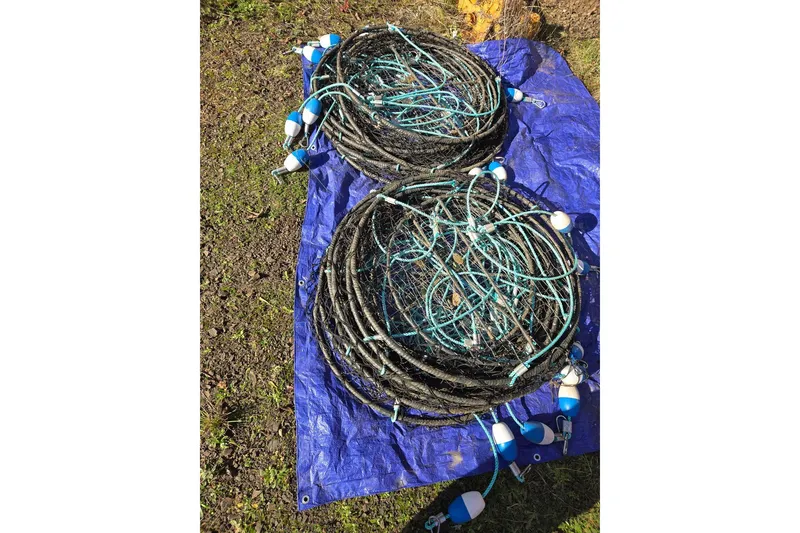 Slide: The Image of Coiled fishing nets with blue floats on a tarp, KingFisher 2825 Coastal Express 2021. - 55