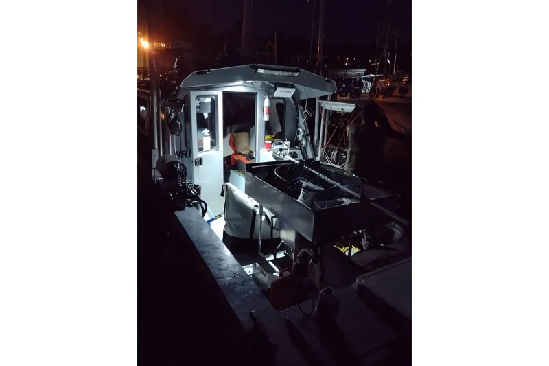 Slide: The Image of 2021 KingFisher 2825 Coastal Express boat illuminated at night in a marina. - 60