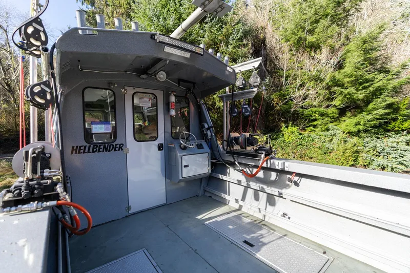 Slide: The Image of 2021 KingFisher 2825 Coastal Express boat interior with equipment and forest backdrop. - 9