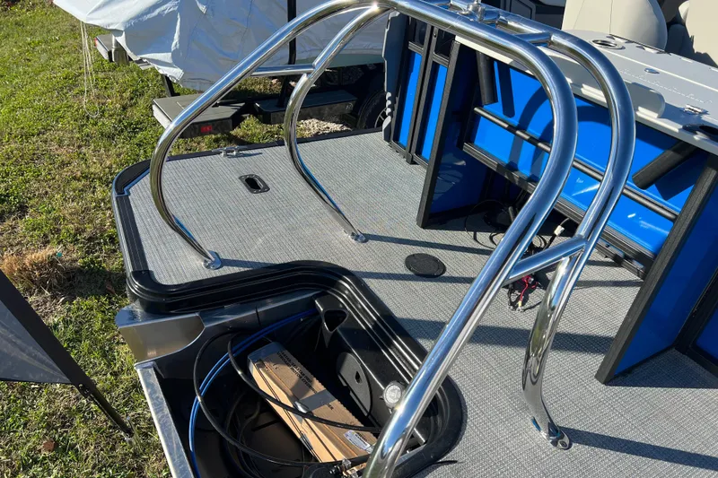 Slide: The Image of 2026 Sylvan R22 Rear Partyfish boat deck with stainless steel railings and storage compartment. - 15