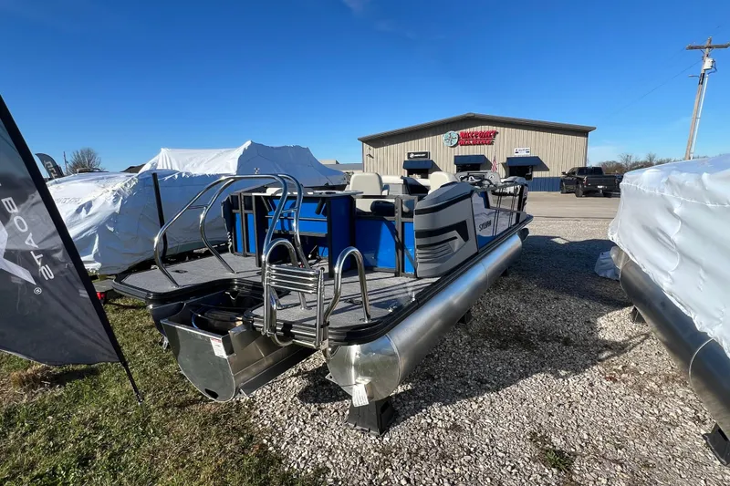 Slide: The Image of 2026 Sylvan R22 Rear Partyfish pontoon boat displayed outdoors on gravel lot. - 16