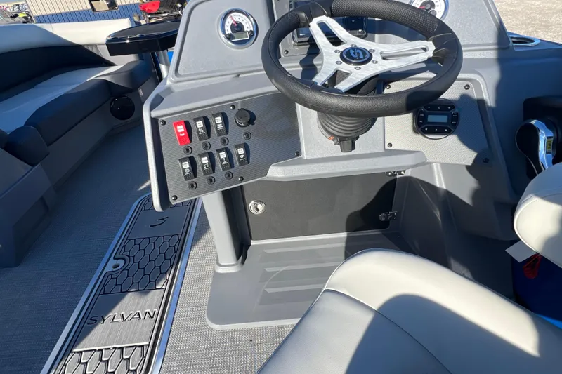 Slide: The Image of 2026 Sylvan R22 Rear Partyfish boat interior with steering wheel and control panel. - 8