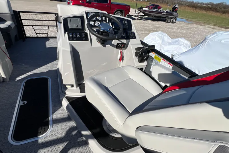 Slide: The Image of 2026 Sylvan X3 DLZ Bar boat interior with steering console and seating. - 14