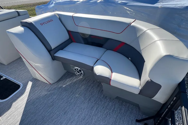 Slide: The Image of 2026 Sylvan X3 DLZ Bar boat seating with gray upholstery and red accents. - 17