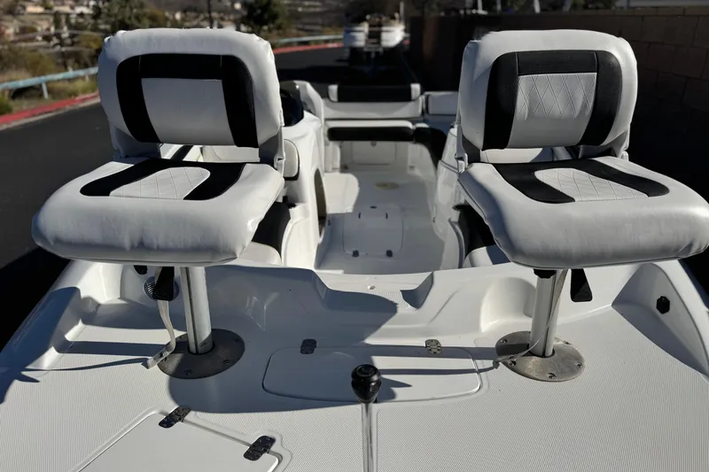 Slide: The Image of 2020 Tahoe 215 Xi boat interior with two cushioned seats, white and black design. - 10