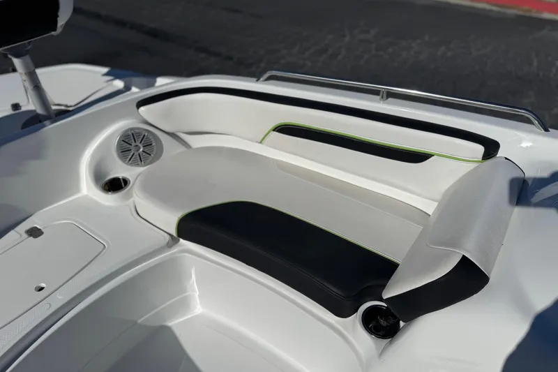 Slide: The Image of 2020 Tahoe 215 Xi boat interior with white and black seating, speaker, and cup holder. - 15