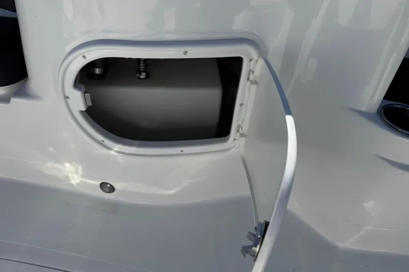 Slide: The Image of Open storage compartment on a 2020 Tahoe 215 Xi boat. - 19