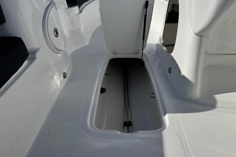 Slide: The Image of 2020 Tahoe 215 Xi boat interior storage compartment, open and empty. - 24