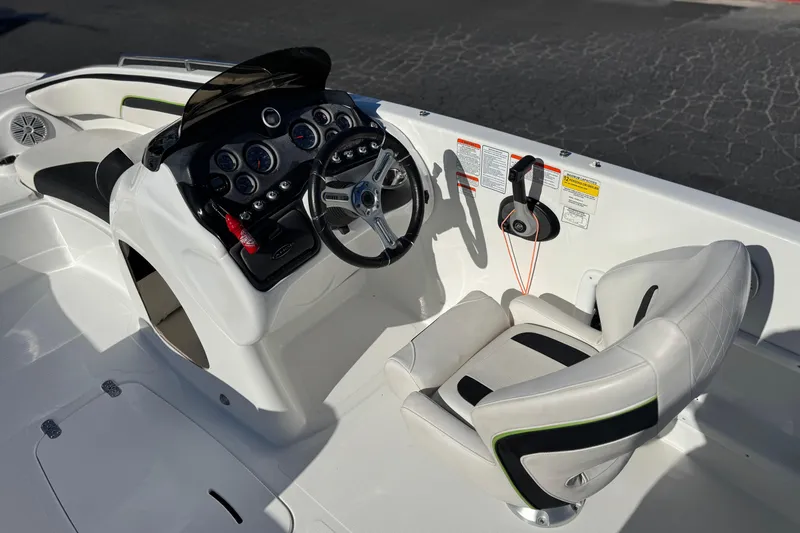 Slide: The Image of 2020 Tahoe 215 Xi boat cockpit with steering wheel and control panel. - 25