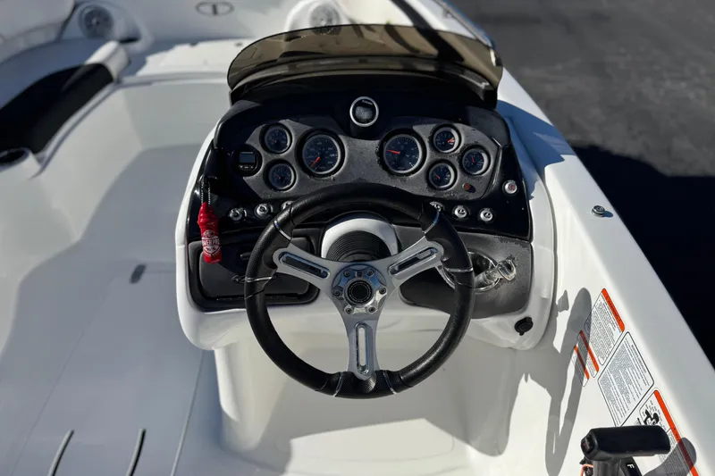 Slide: The Image of 2020 Tahoe 215 Xi boat dashboard with steering wheel and instrument panel. - 26