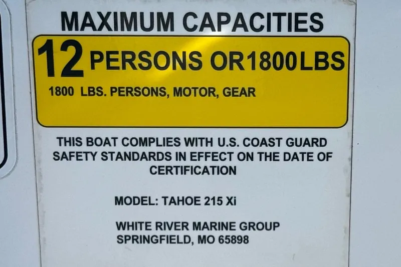 Slide: The Image of 2020 Tahoe 215 Xi boat capacity label: 12 persons or 1800 lbs, U.S. Coast Guard compliant. - 30