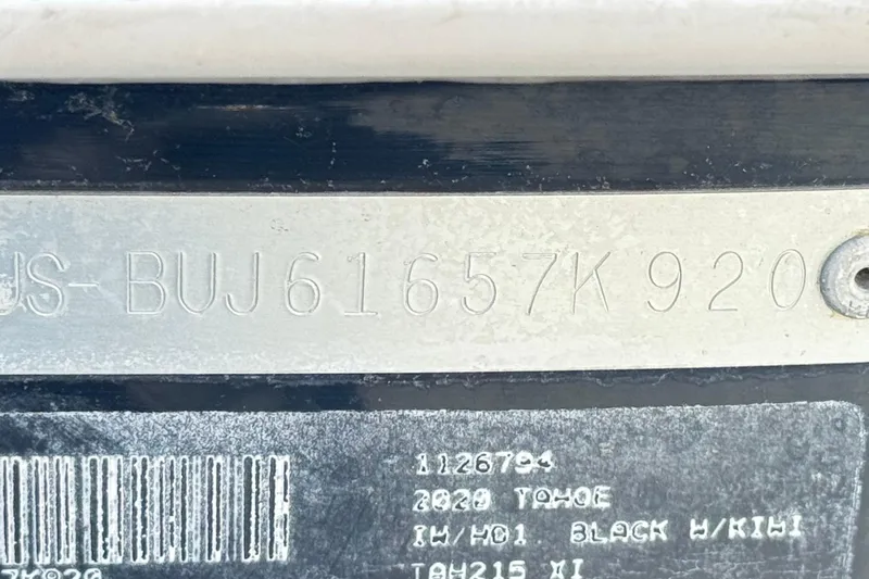 Slide: The Image of VIN plate of a 2020 Tahoe 215 Xi, black with kiwi accents. - 31