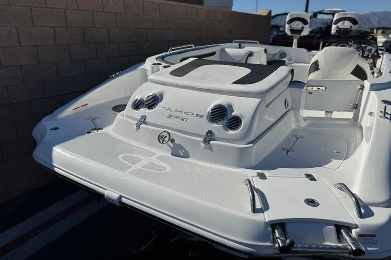 Slide: The Image of 2020 Tahoe 215 Xi boat, white deck, sleek design, outdoor setting. - 7