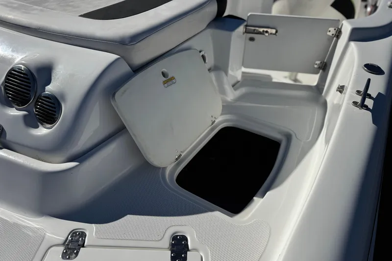 Slide: The Image of 2020 Tahoe 215 Xi boat interior with open storage compartments and sleek design. - 8