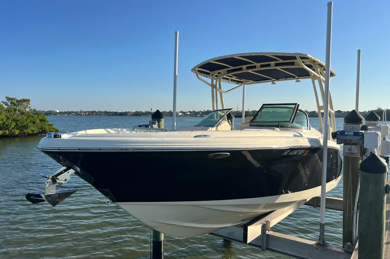The Image of 2017 Chris-Craft Calypso 26 boat docked on a sunny day by the water. - 0