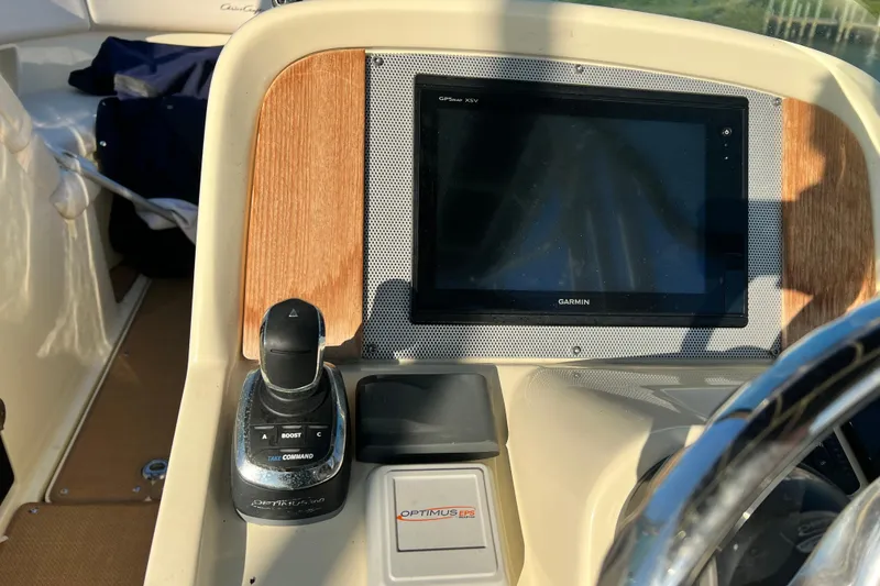 Slide: The Image of 2017 Chris-Craft Calypso 26 dashboard with Garmin display and control panel. - 10