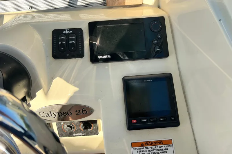 Slide: The Image of 2017 Chris-Craft Calypso 26 dashboard with Yamaha and Garmin controls. - 11