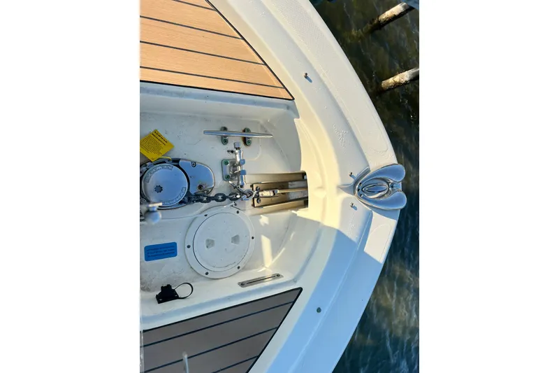 Slide: The Image of 2017 Chris-Craft Calypso 26 boat deck with anchor and chain mechanism. - 13