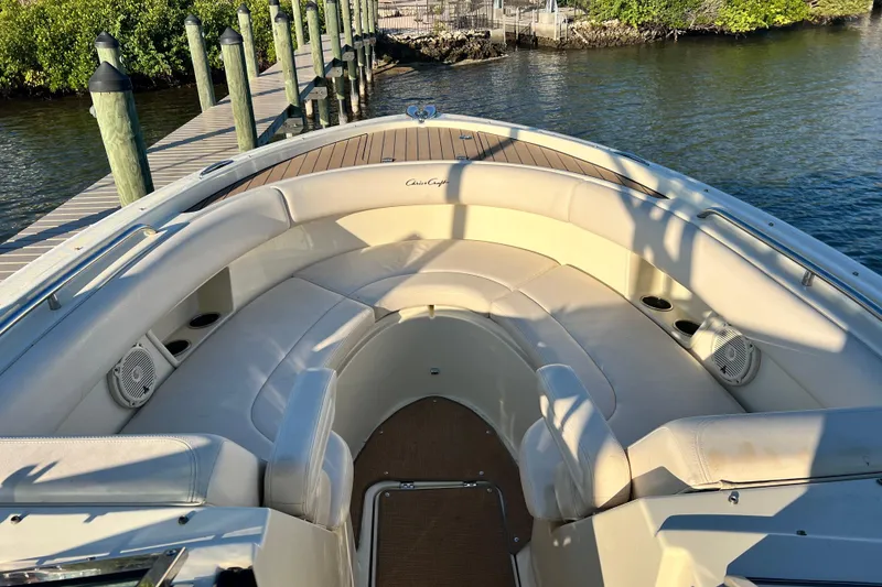 Slide: The Image of 2017 Chris-Craft Calypso 26 boat interior with plush seating and dock view. - 14