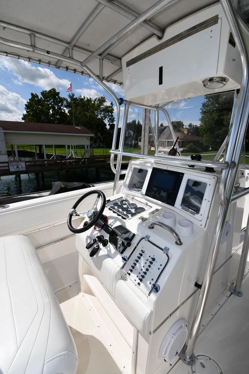 Slide: The Image of 2000 Fountain 31 Tournament Edition boat cockpit with steering wheel and control panel. - 13
