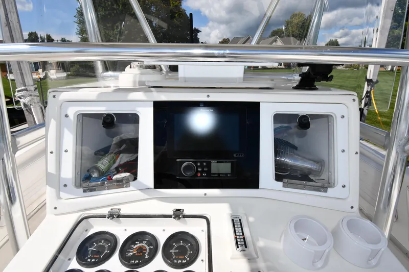 Slide: The Image of Center console of 2000 Fountain 31 Tournament Edition boat with gauges and electronics. - 14