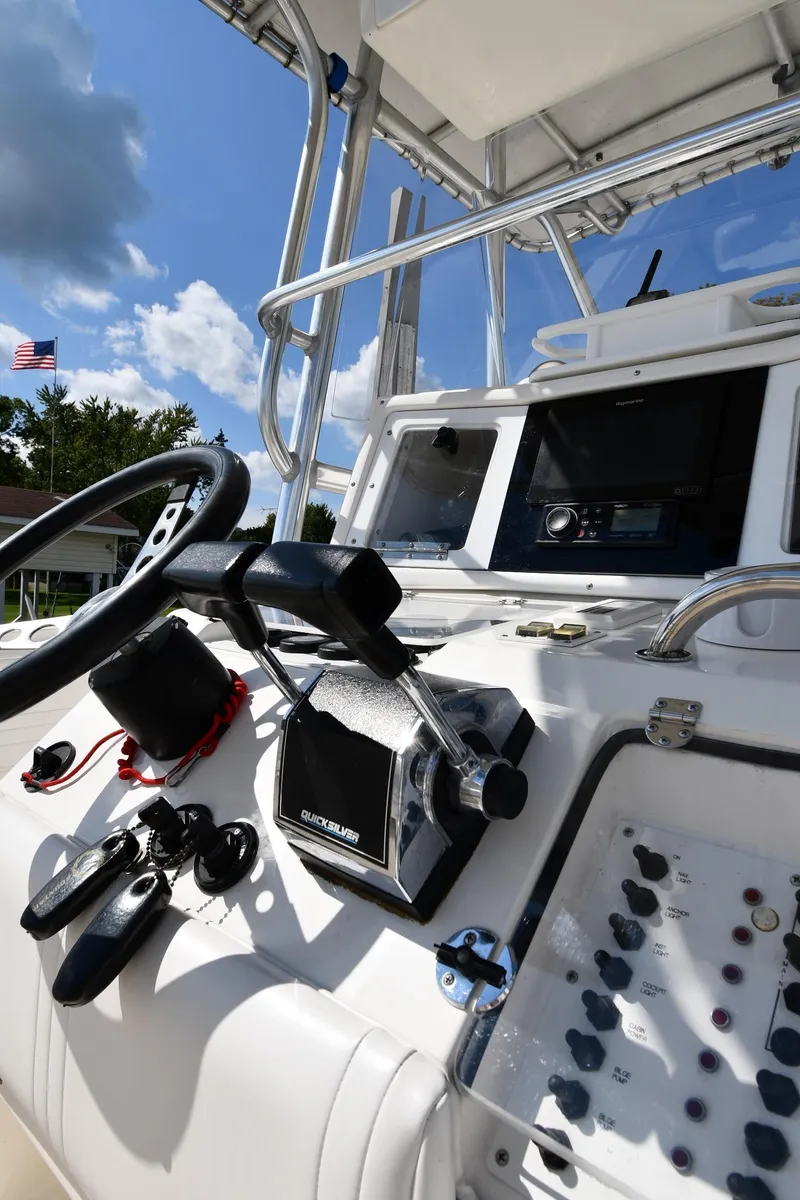 Slide: The Image of Control panel of a 2000 Fountain 31 Tournament Edition boat under a clear sky. - 15